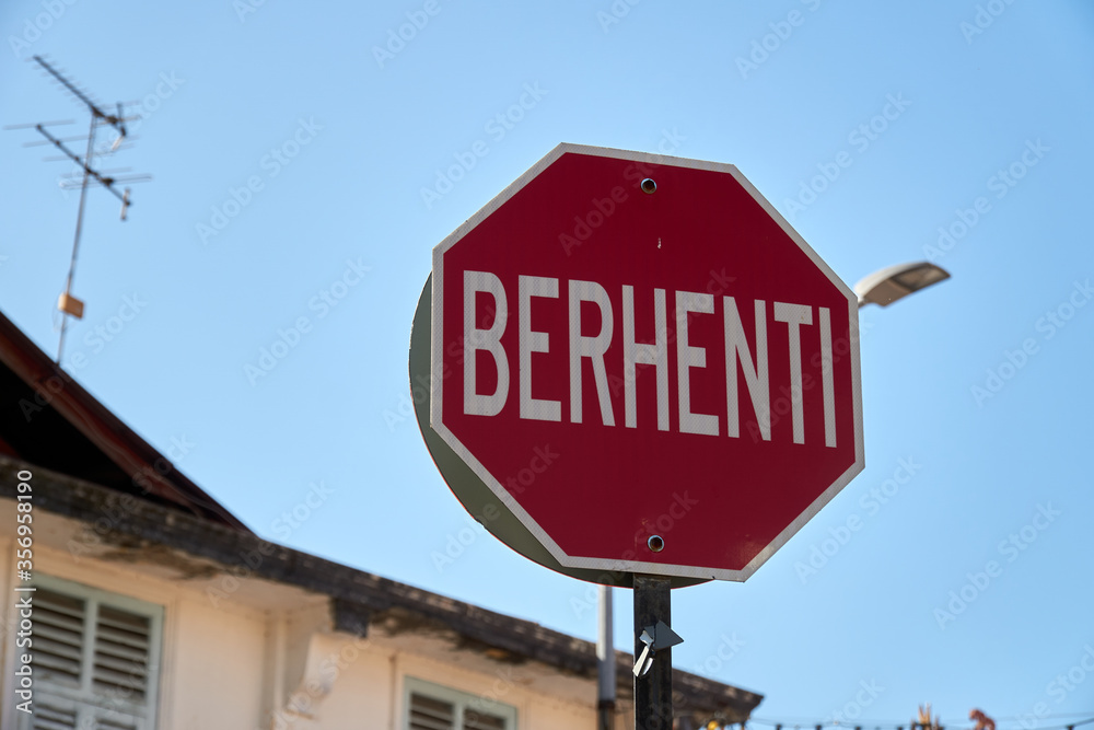 Traffic sign in Malaysia with Malay word ‘Berhenti’ which means Stop