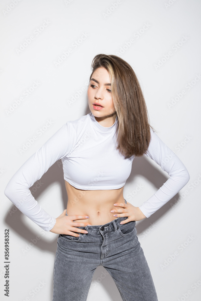 Young pretty woman isolated posing in the studio isolated on white background Young pretty woman isolated posing in the studio isolated on white background