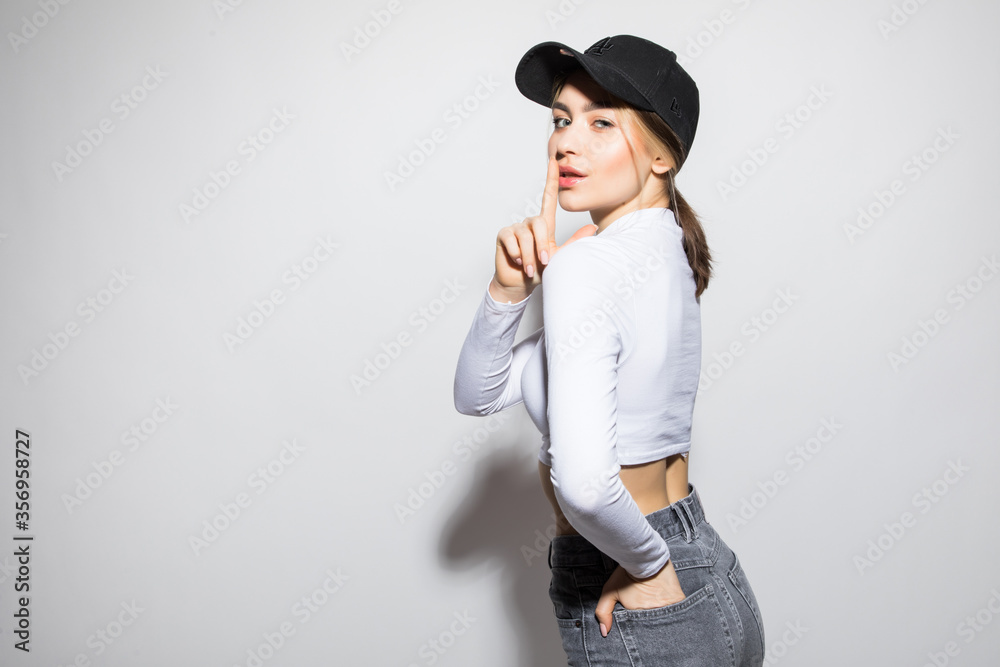 Closeup portrait of young woman wearing in black cap, protect from the sun rays, isolated on white studio background. Positive people emotion concept Closeup portrait of young woman wearing in black cap, protect from the sun rays, isolated on white studio background. Positive people emotion concept