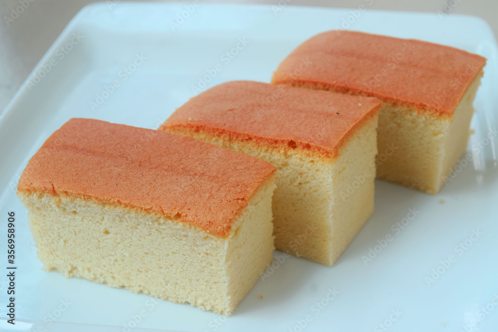 Closeup view 3 slice of Japanese Cotton sponge cake on white plate. Delicious cake ready to serve on a white plate. Closeup view 3 slice of Japanese Cotton sponge cake on white plate. Delicious cake ready to serve on a white plate.