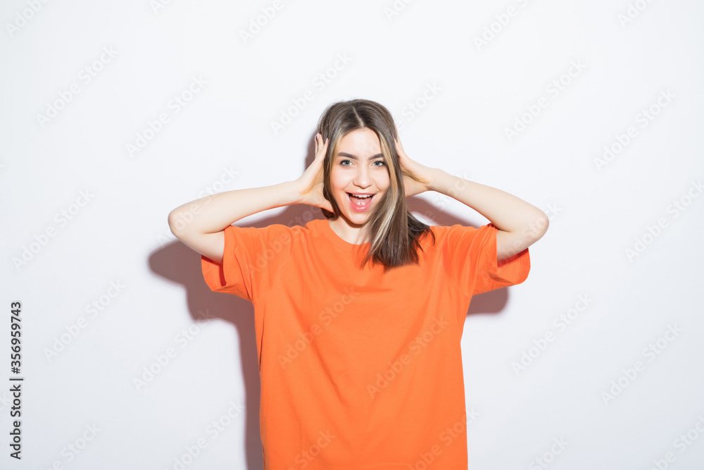 Close-up portrait of surprised beautiful girl holding her head in amazement and open-mouthed over white background. Close-up portrait of surprised beautiful girl holding her head in amazement and open-mouthed over white background.