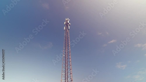 Cellular antenna tower and electronic radio transceiver equipment part of a cellular network under the blue sky. Radio transceiver pilon. 