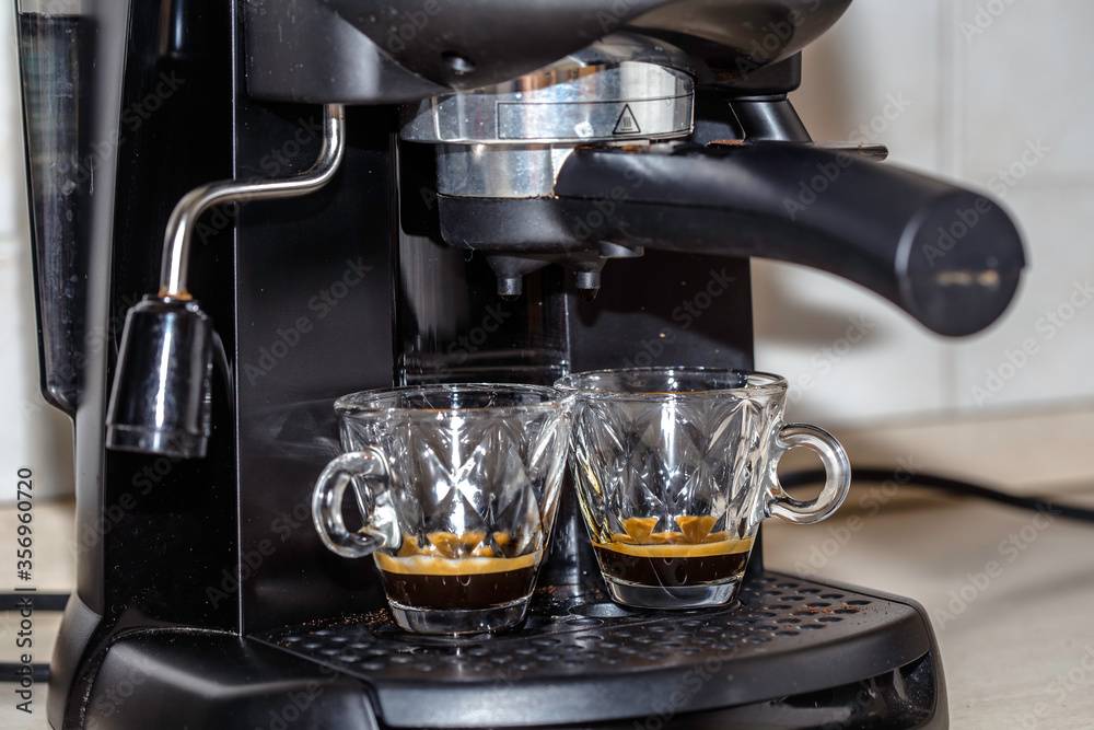 Process of making two espresso shots using espresso machine. Italian coffee. Process of making two espresso shots using espresso machine. Italian coffee.
