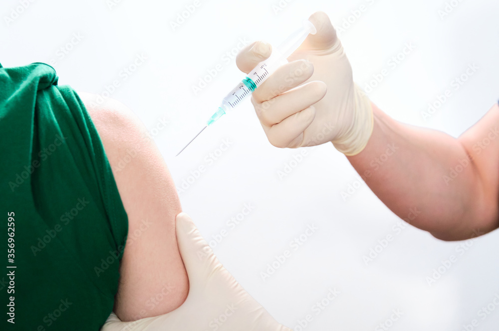 Unrecognizable nurse vaccinating a patient Unrecognizable nurse vaccinating a patient