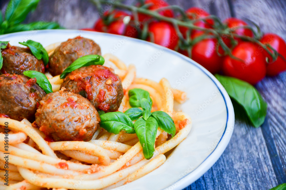 Spaghetti pasta Italian home made meal. Mediterranean food concept .Spaghetti pasta meatballs with tomato sauce, basil, herbs ,parmesan cheese Spaghetti pasta Italian home made meal. Mediterranean food concept .Spaghetti pasta meatballs with tomato sauce, basil, herbs ,parmesan cheese