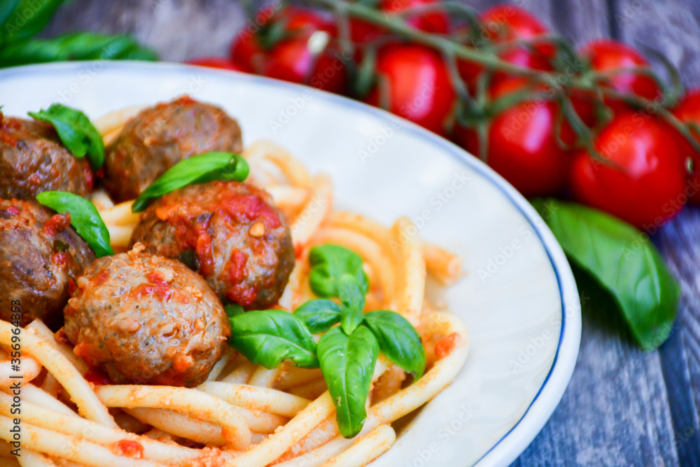 Spaghetti pasta Italian home made meal. Mediterranean food concept .Spaghetti pasta meatballs with tomato sauce, basil, herbs ,parmesan cheese Spaghetti pasta Italian home made meal. Mediterranean food concept .Spaghetti pasta meatballs with tomato sauce, basil, herbs ,parmesan cheese
