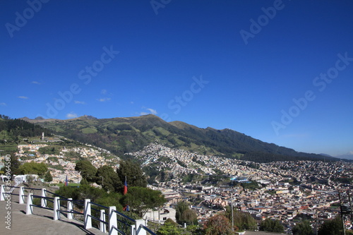 Vantage point overlooking a suburb of Quito, Ecuador. Volcanic mountains can be seen in the distance. 