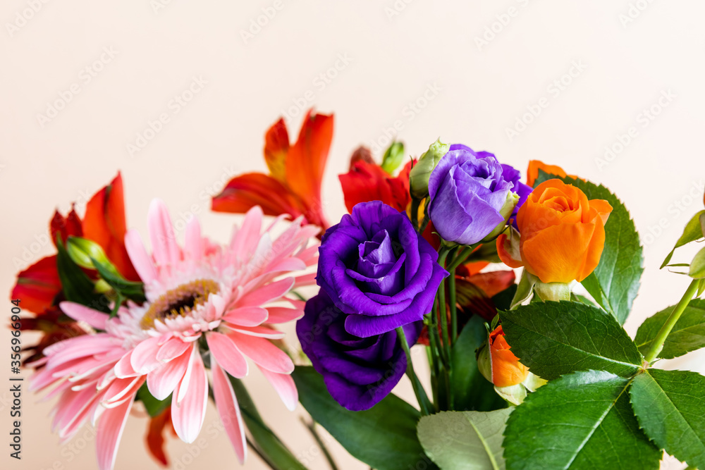 Floral composition with bouquet of colorful flowers isolated on beige, selective focus