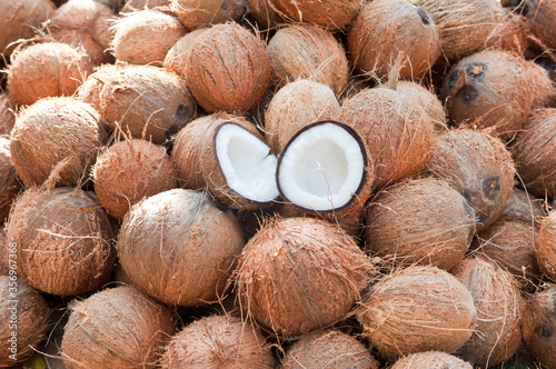 Fototapeta Coconuts cut in half and whole coconuts