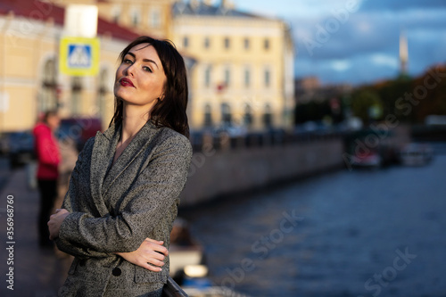 Fotografie Woman in gray pantsuit walks on promenade