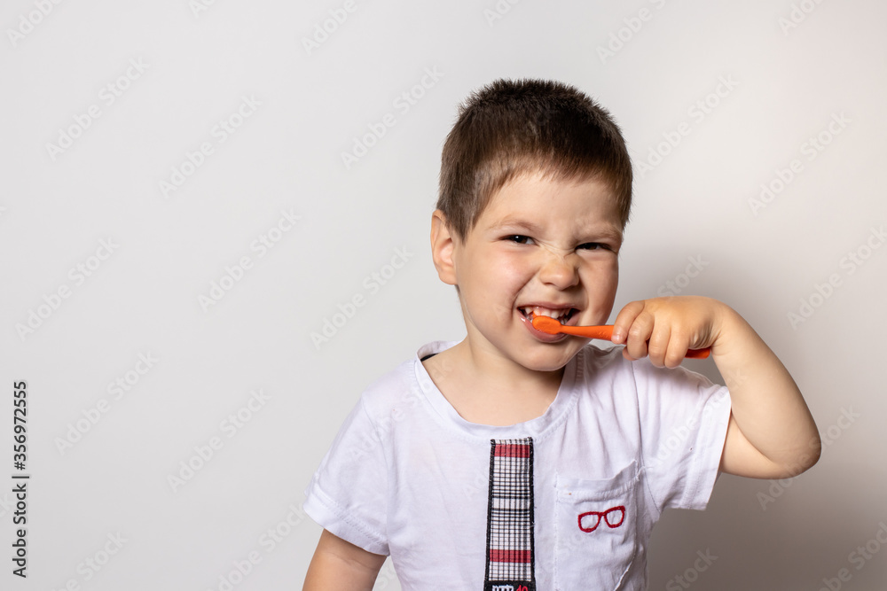 Cute little boy brushing teeth, isolated on white Cute little boy brushing teeth, isolated on white
