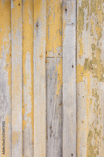 Wooden surface with old blue and yellow paint. Old grunge wooden wall. Wooden texture.