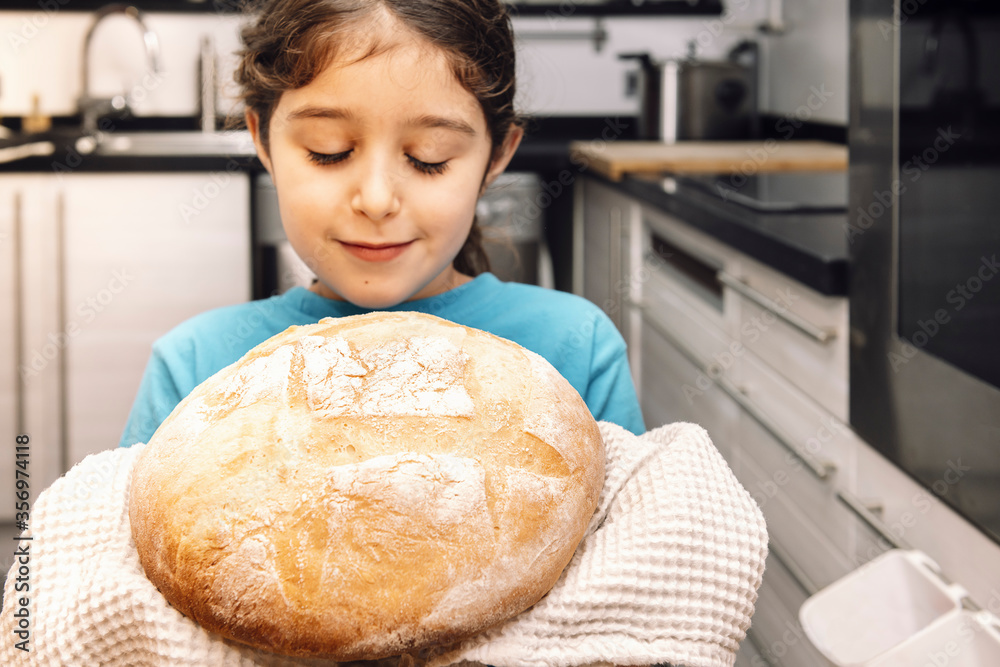 child smelling freshly baked bread