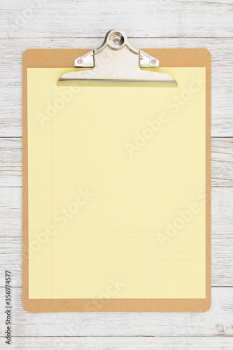 Clipboard with blank paper on weathered whitewash wood
