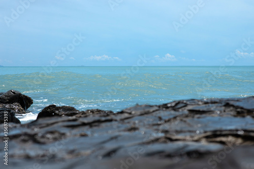 Wave crashing on the rocky reef © somchaichoosiri