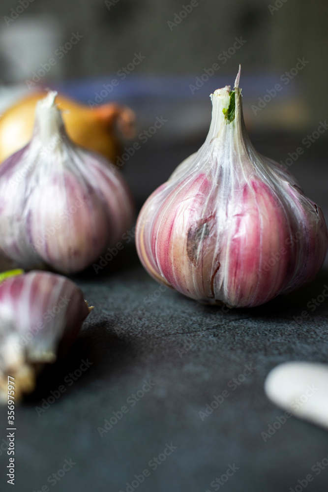 Obraz premium Garlic, onions and beans on a dark background. Still life with onions of garlic and onions. Top view with place for text.