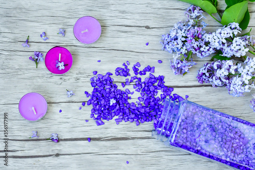 lilac flowersand salt  for SPA on the wooden table photo