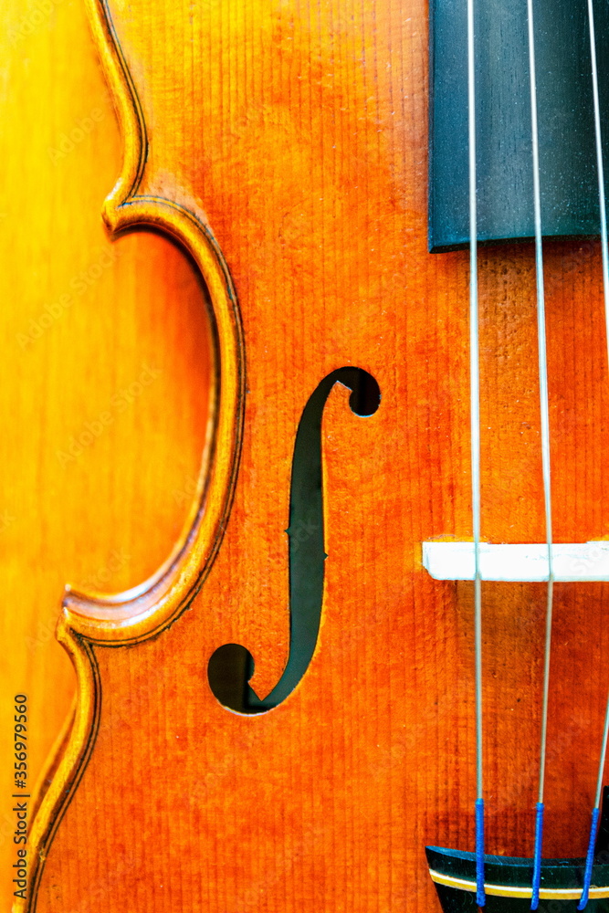 Detail of a violin on a wooden table Detail of a violin on a wooden table