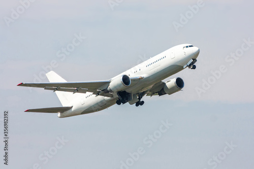 Take-off of a white passenger wide-body aircraft