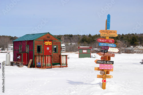 Signs point the way to a multitude of ice fishing shacks on Lake Winnipesaukee photo