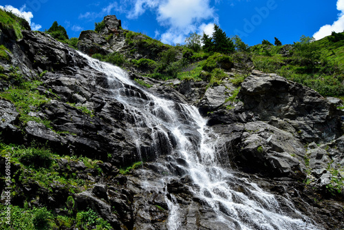 Capra Waterfall next to Transfagarasan alpine mountain road in southern section of Carpathian Mountains in Romania