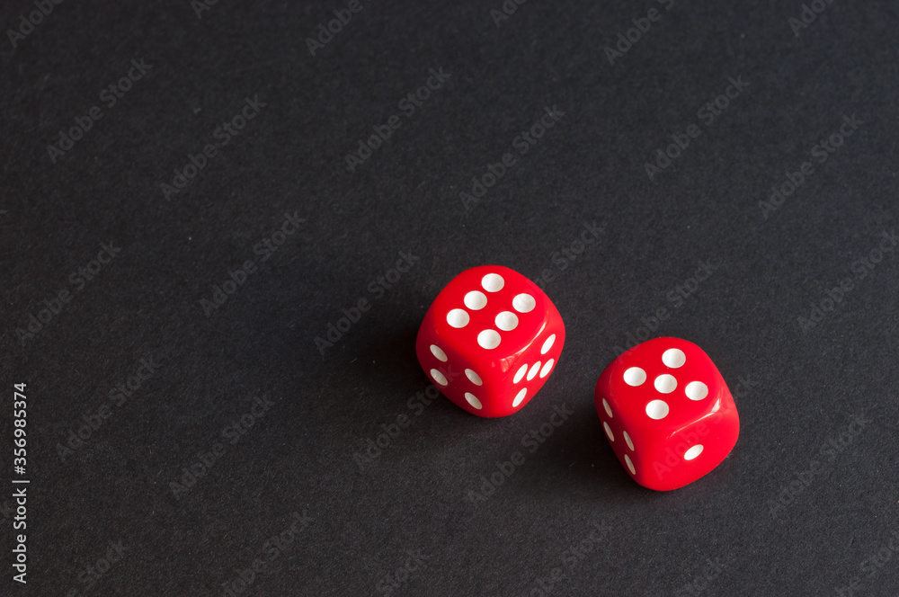 red dice on black background. concept: luck. place for inscription. red dice on black background. concept: luck. place for inscription.