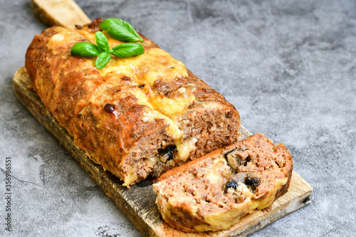 Home made baked  delicious  italian  traditional meatloaf filled  with cheese and mushrooms 