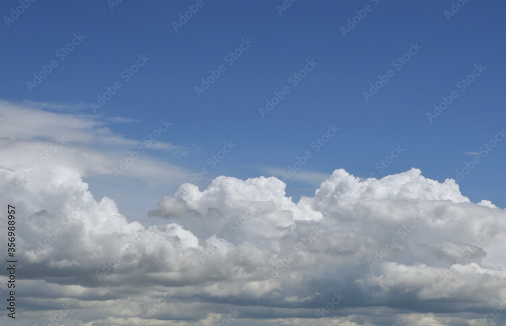 Aerial view on moody thunder clouds flying on horizon under blue sky Aerial view on moody thunder clouds flying on horizon under blue sky