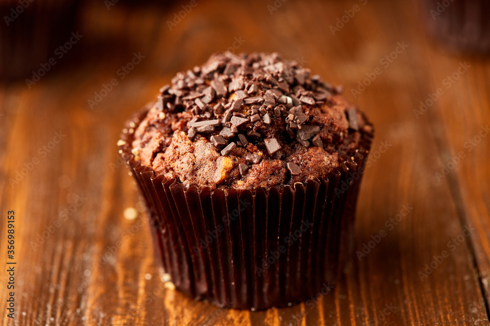 Traditional fresh dessert chocolate muffin on wooden background Traditional fresh dessert chocolate muffin on wooden background