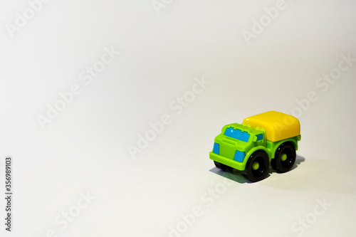 Green toy truck close up with bright white background