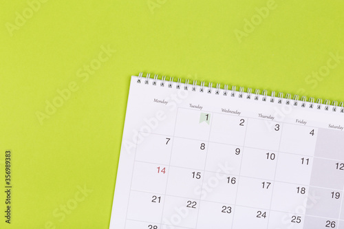 calendar on the table with green background, planning a business meeting or travel planning concept