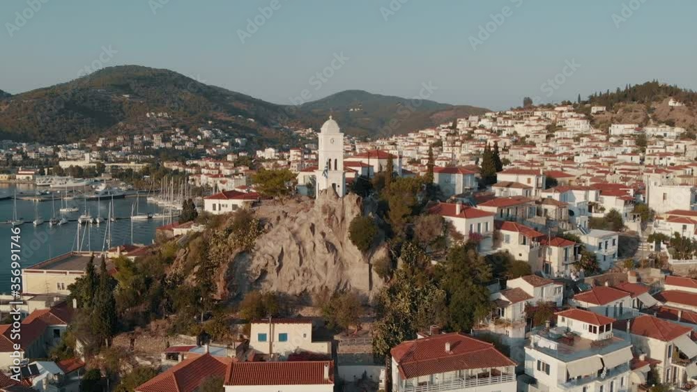 Drone bid’s eye view of Poros island. Old town promenade, marina harbour and sea strait. Saronic gulf, Greece, Europe. Drone bid’s eye view of Poros island. Old town promenade, marina harbour and sea strait. Saronic gulf, Greece, Europe.
