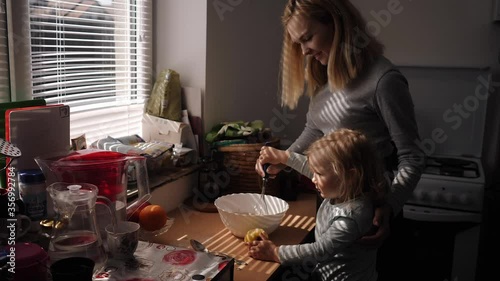 Mother and daughter preparing cookies in the kitchen