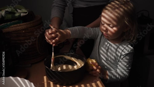 Mother and daughter preparing cookies in the kitchen