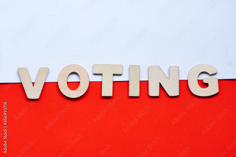 President voting wooden letters inscription-translation wybory-in Poland on coronavirus pandemia time. Politician flatly on white-red polish flag. Political elections. President voting wooden letters inscription-translation wybory-in Poland on coronavirus pandemia time. Politician flatly on white-red polish flag. Political elections.