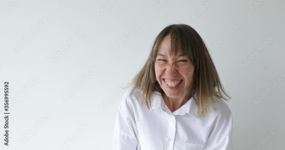 Portrait young woman looking at camera with happy emotion enjoying successful lifestyle on white background