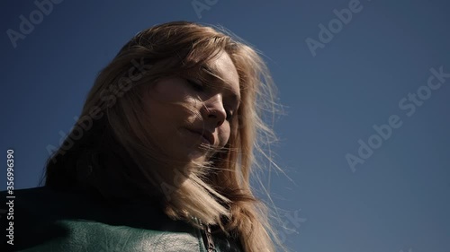 a young woman is developing hair on the sky view from below
