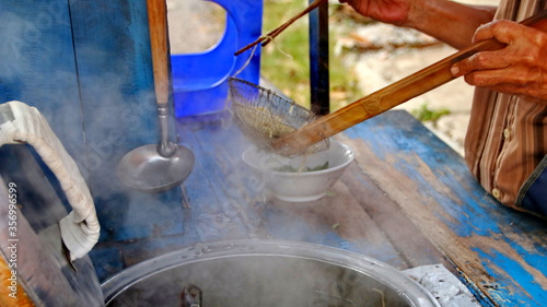 Indonesian food  mie ayam  noodles with chicken presented directly by the seller on the cart