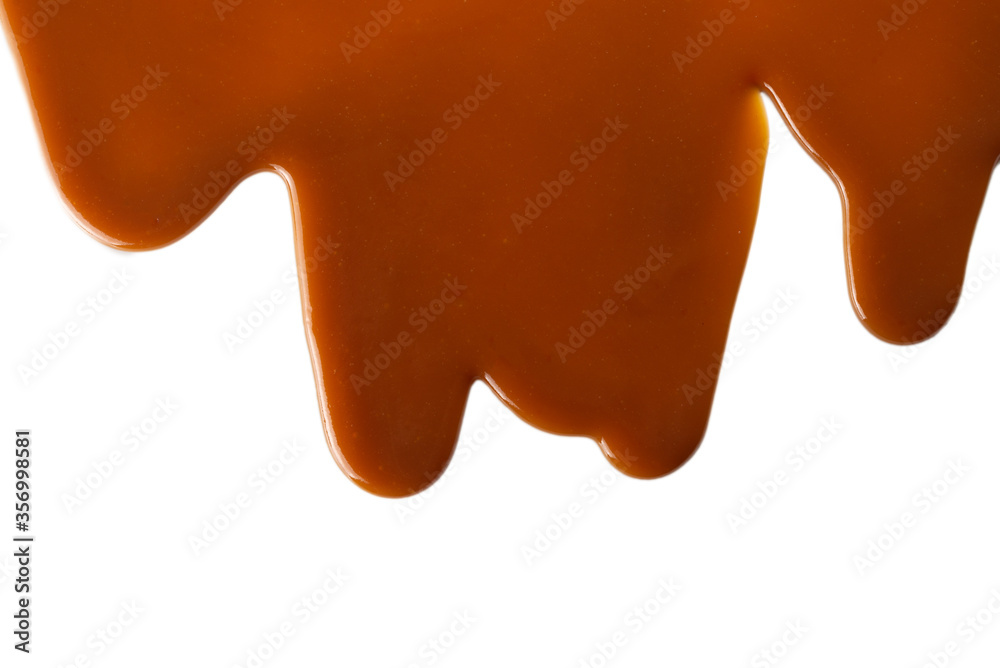 Background of flowing caramel sauce isolated on white. Background of flowing caramel sauce isolated on white.
