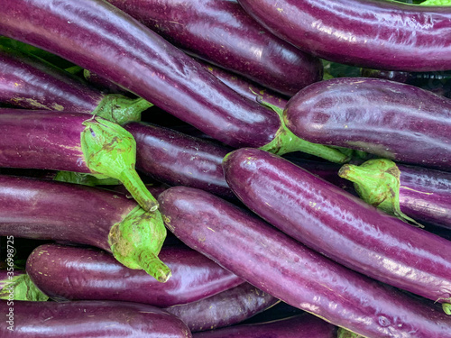 Pile of fresh eggplants photo for healthy food concept