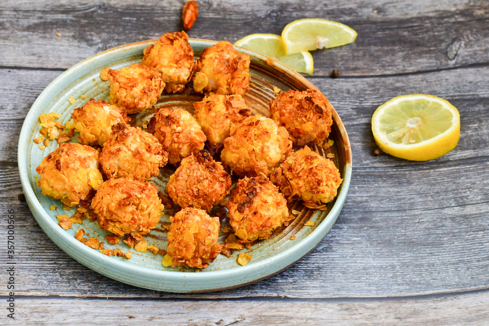 Home made Crispy Chicken Popcorn with honey mustard sauce on wooden background Home made Crispy Chicken Popcorn with honey mustard sauce on wooden background