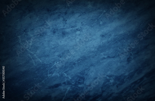 beautiful texture of decorative blue stone marble for backgrounds. abstract vignette blue background with dark gradient corner.