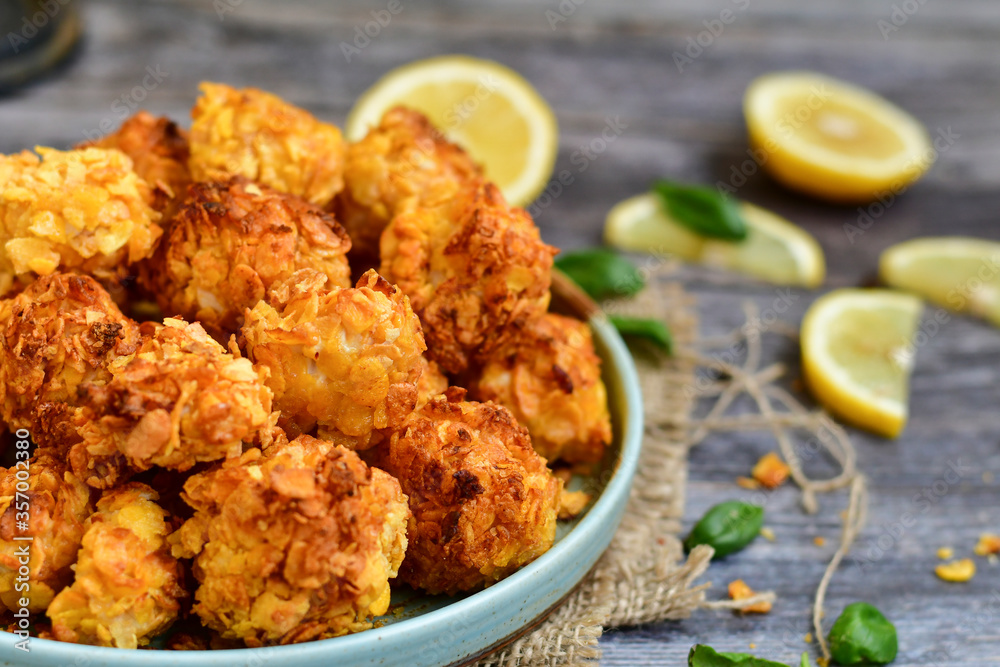 Home made Crispy Popcorn Chicken with honey mustard sauce on wooden background Home made Crispy Popcorn Chicken with honey mustard sauce on wooden background