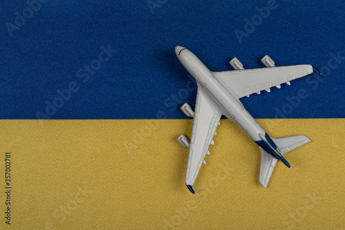 Flag of Ukraine and model airplane. Resumption of flights after quarantine, opening borders. Travel to Ukraine