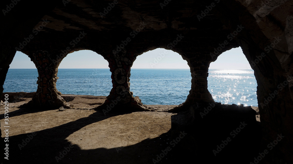 
Tres orificios en un muro de piedra permiten ver el mar en la ciudad de Calpe