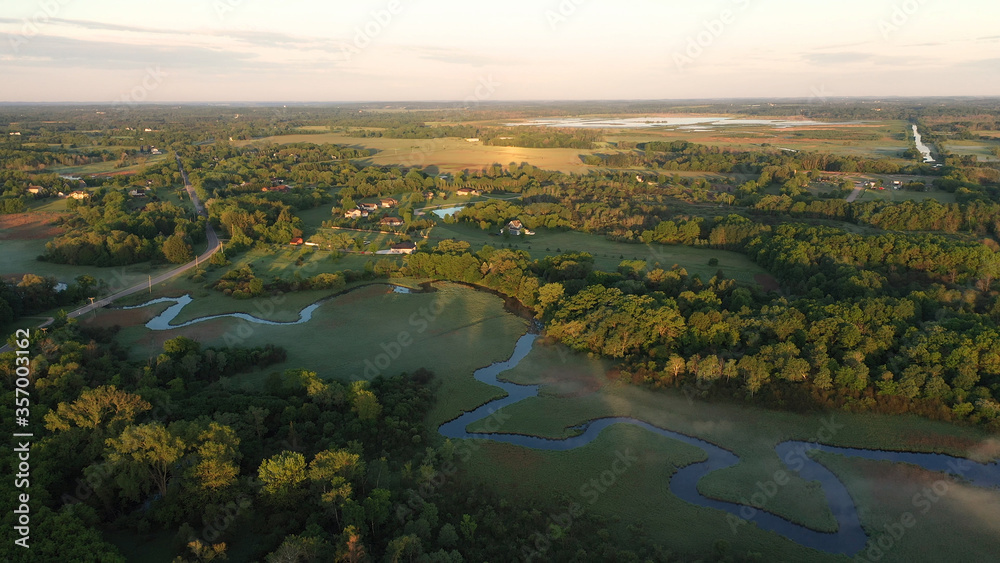 Aerial view of american countryside in the summertime. Sunrise, dawn, misty early morning. North american rural landscape,  Beautiful nature of Midwest