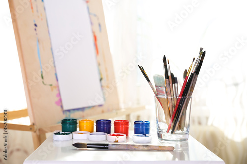 art paint brushes on an easel background