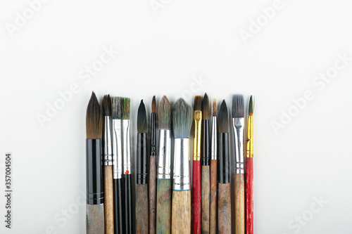 art background with paint brushes top view with copy space.