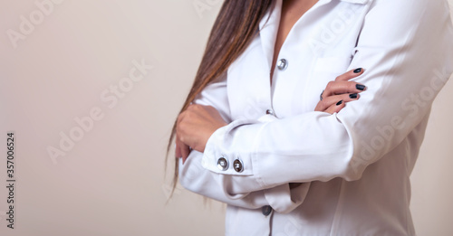 Crossed arms doctor woman in a white coat.