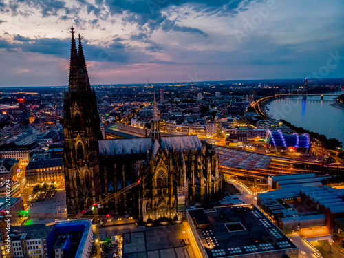 Colgne Koln Cathedral during sunset , drone aerial vie over Cologne and the river rhein during sunset in Germany Europe dusk photo